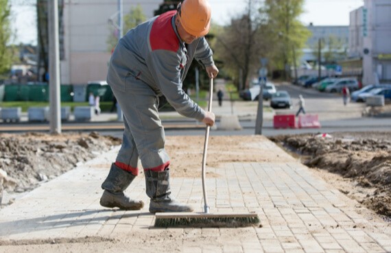 A First Response Cleaning post-renovation specialist sweeps new interlock b