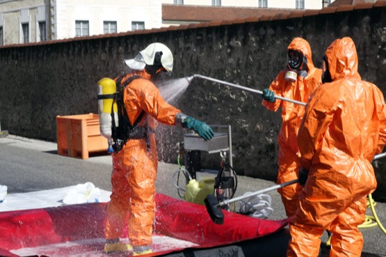 crime-scene-1 (2) cleaners in hazmat suits decontaminating another cleaner.
