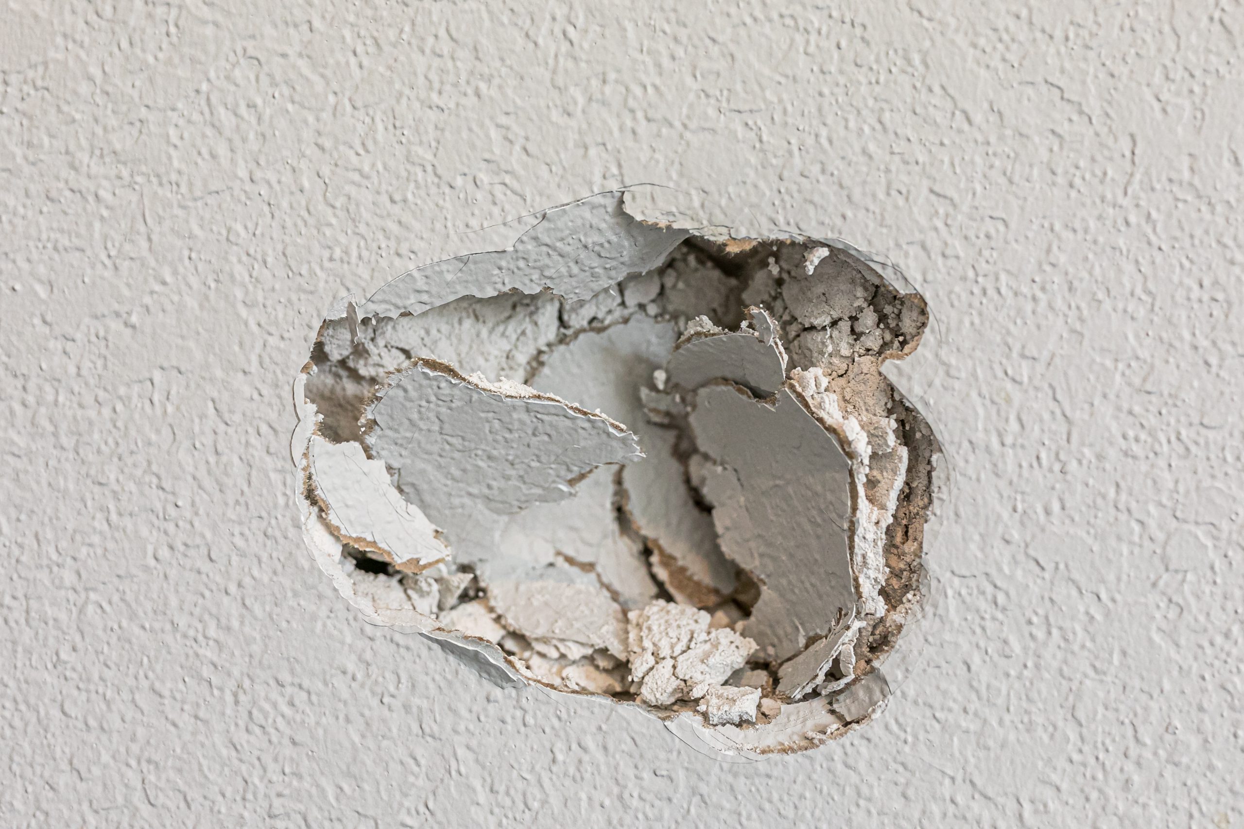 A,Hole,In,The,Wall,Of,A,Hallways,Caused,By Hole in a Wall