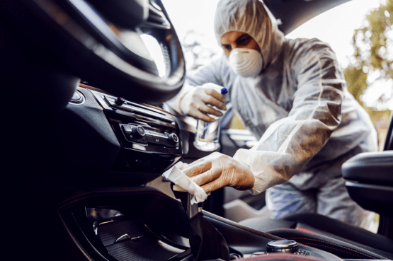 Vehicle decontamination expert cleaning a car.